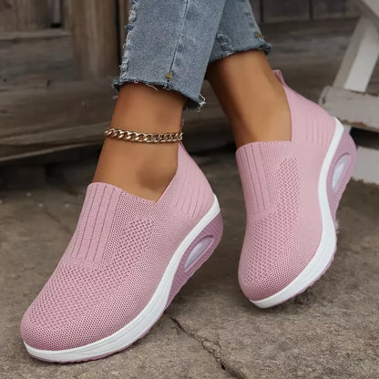 a person wearing pink air cushion , showcasing the textured knit and white chunky sole