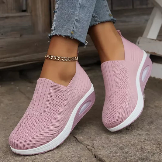a person wearing pink air cushion , showcasing the textured knit and white chunky sole